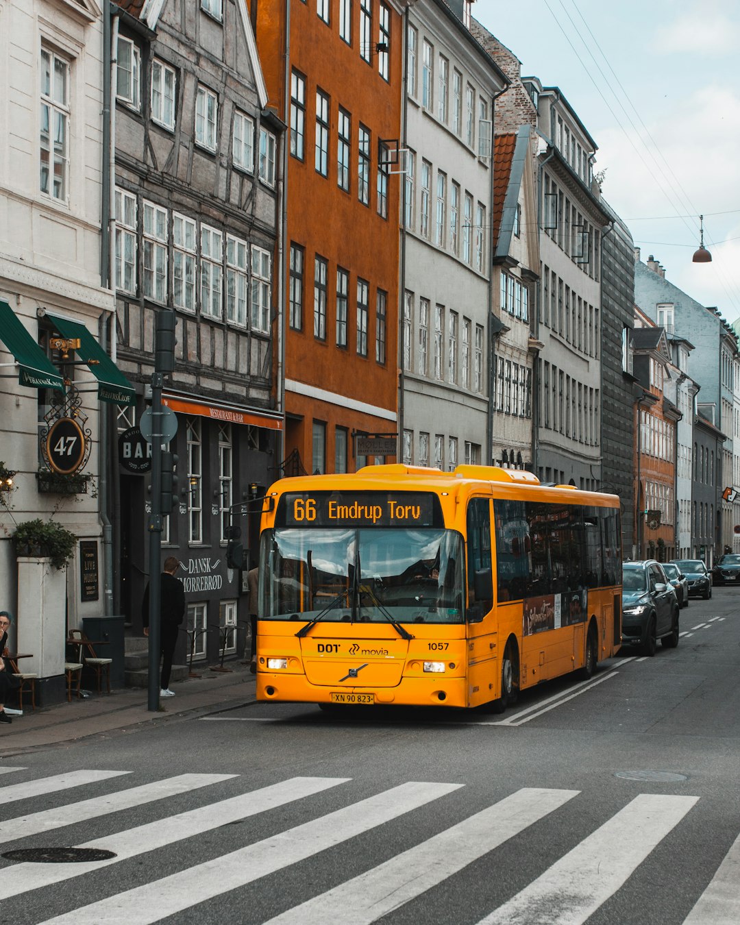 yellow-and-black-bus-on-road-at-daytime-jtpcrnqp2mc